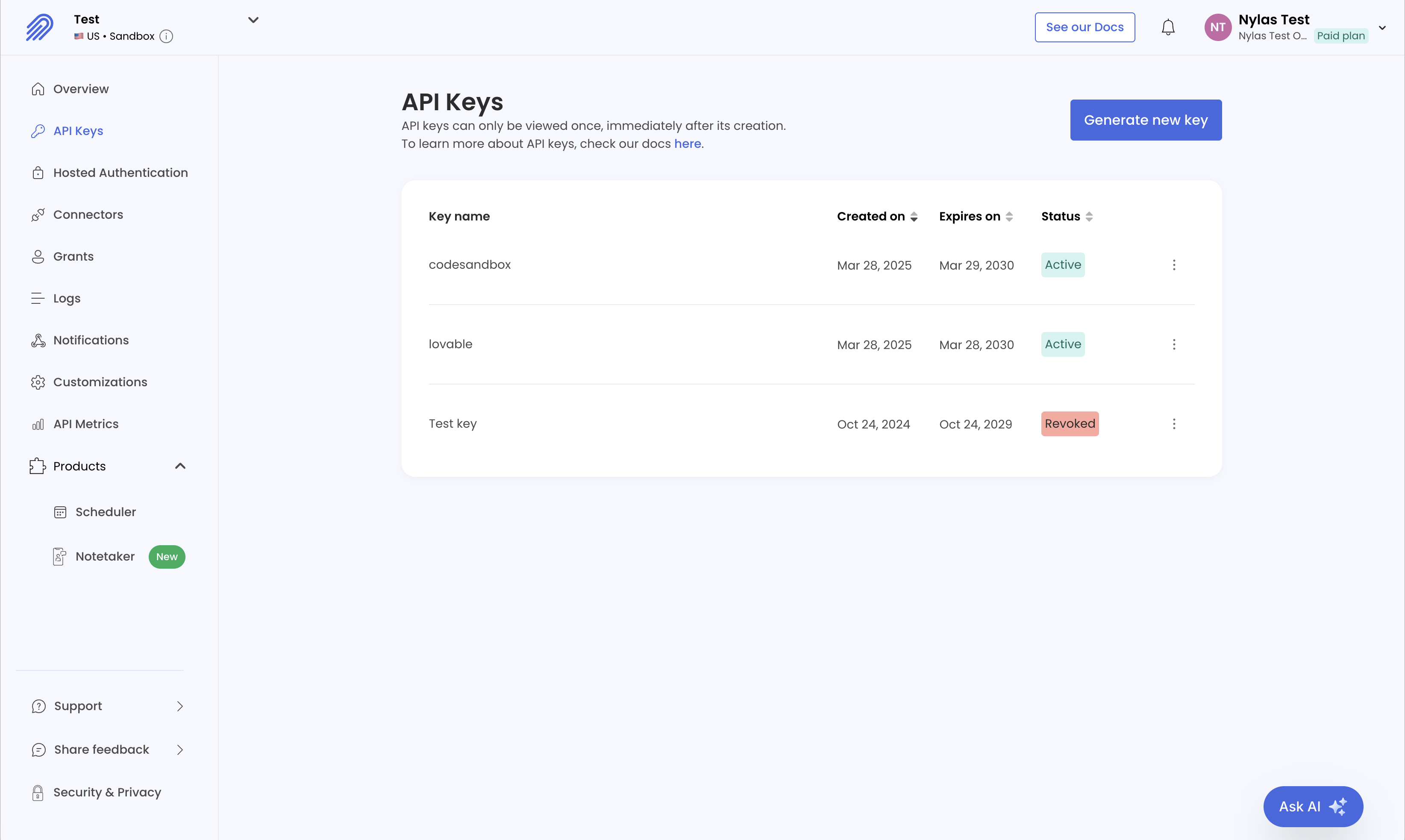 The Nylas Dashboard showing the API Keys page for a Development application. Three API keys are listed. Two are active, and one is revoked.